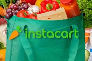 Instacart logo in front of grocery bag full of fruits and vegetables