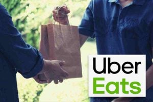 man handing food delivery to another man